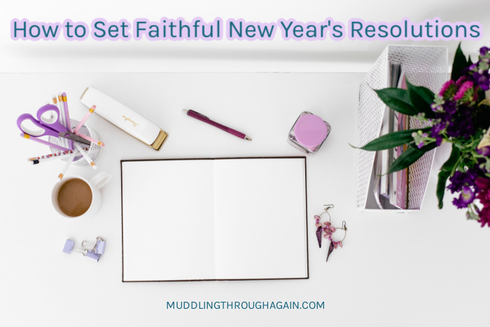 Flat lay of purple office supplies, open blank journal, and purple flowers. Text overlay reads: "How to Set Faithful New Year's Resolutions"